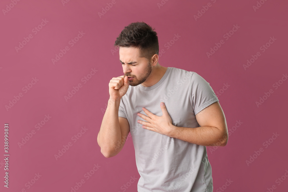 Coughing young man on color background Coughing young man on color background