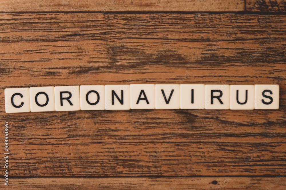 letter tiles spell coronavirus