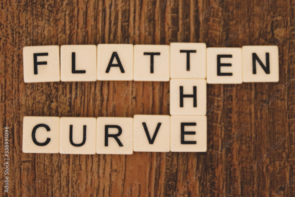 Fototapeta premium Flatten the Curve - tiled letters in a crossword pattern