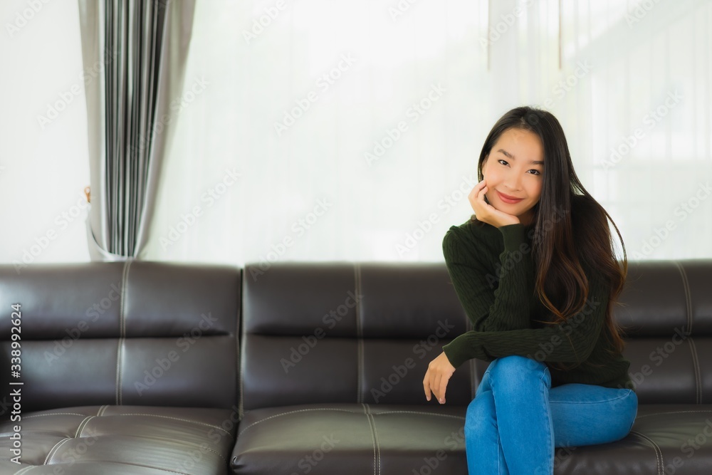 Beautiful portrait young asian woman sit relax on sofa