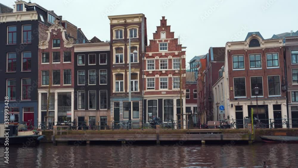 Traditional old dancing houses or buildings in Amsterdam city downtown without tourists due to Coronavirus Covid-19, the Netherlands Traditional old dancing houses or buildings in Amsterdam city downtown without tourists due to Coronavirus Covid-19, the Netherlands