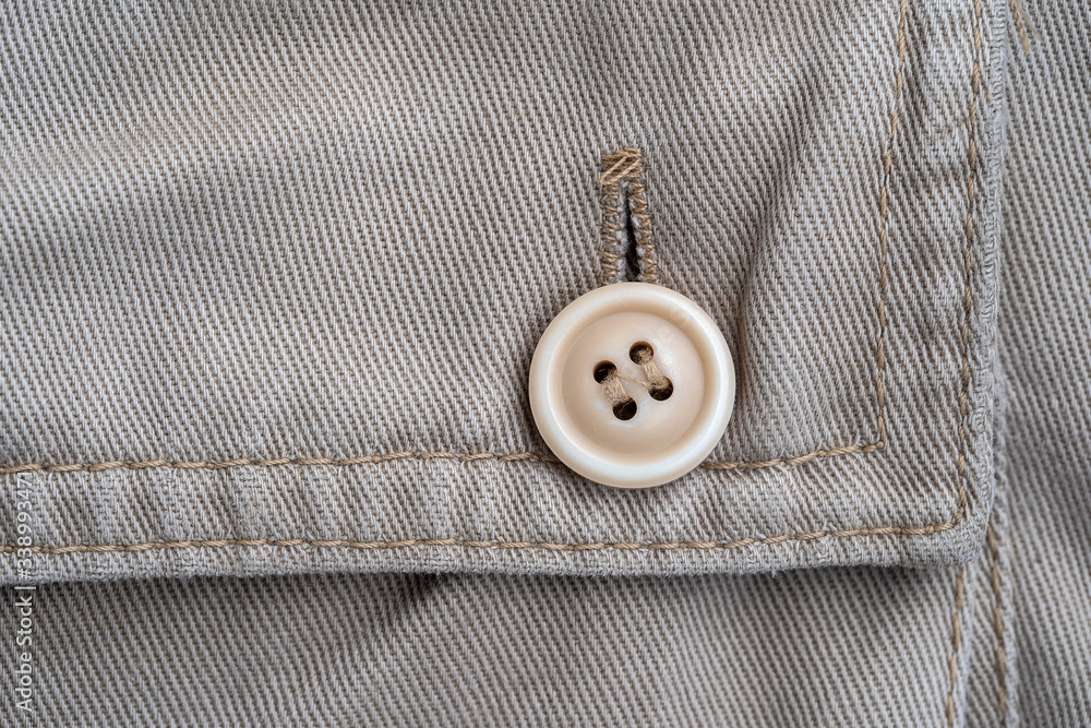 Trouser pocket with button, closeup. Backside view with buttoned pocketon the pants Trouser pocket with button, closeup. Backside view with buttoned pocketon the pants
