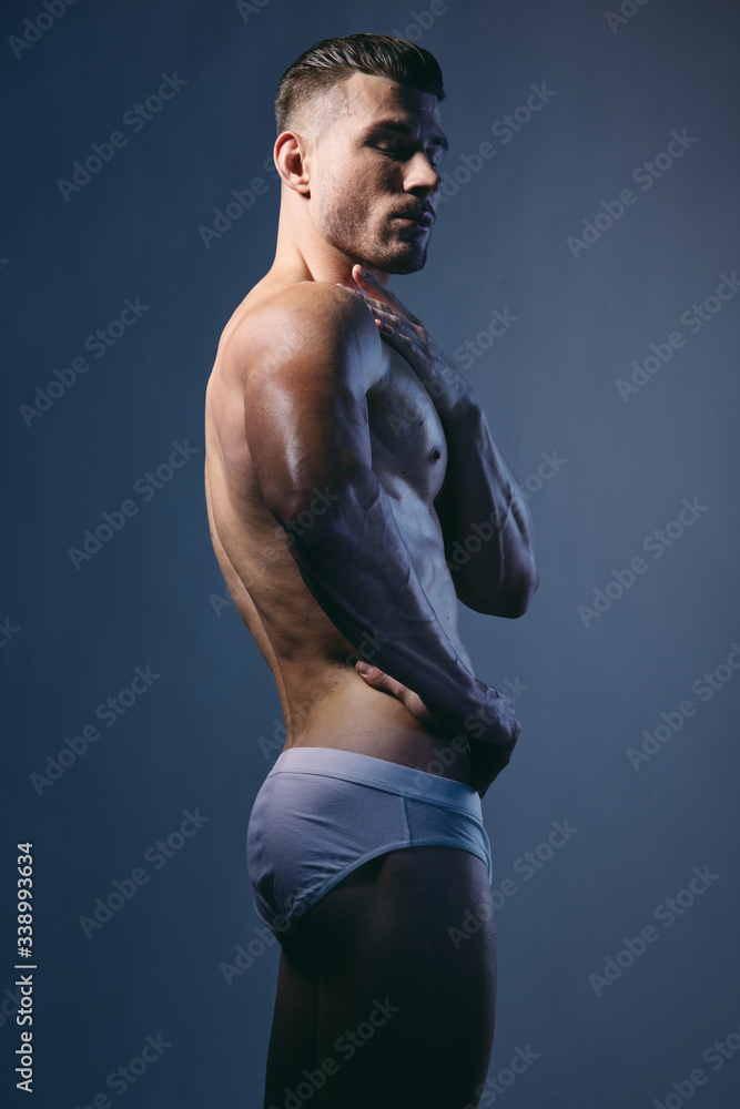 Naklejka premium Athletic man with a muscular body-builded bodybuilder
