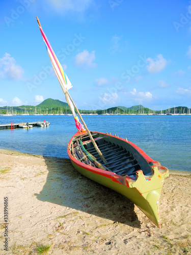 Small traditional sailing boat of the yole ronde style (a yawl boat) in French Caribbean islands.