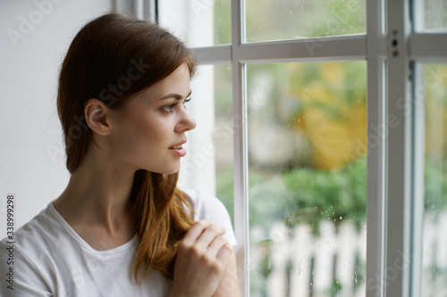 portrait of a young woman looking out window