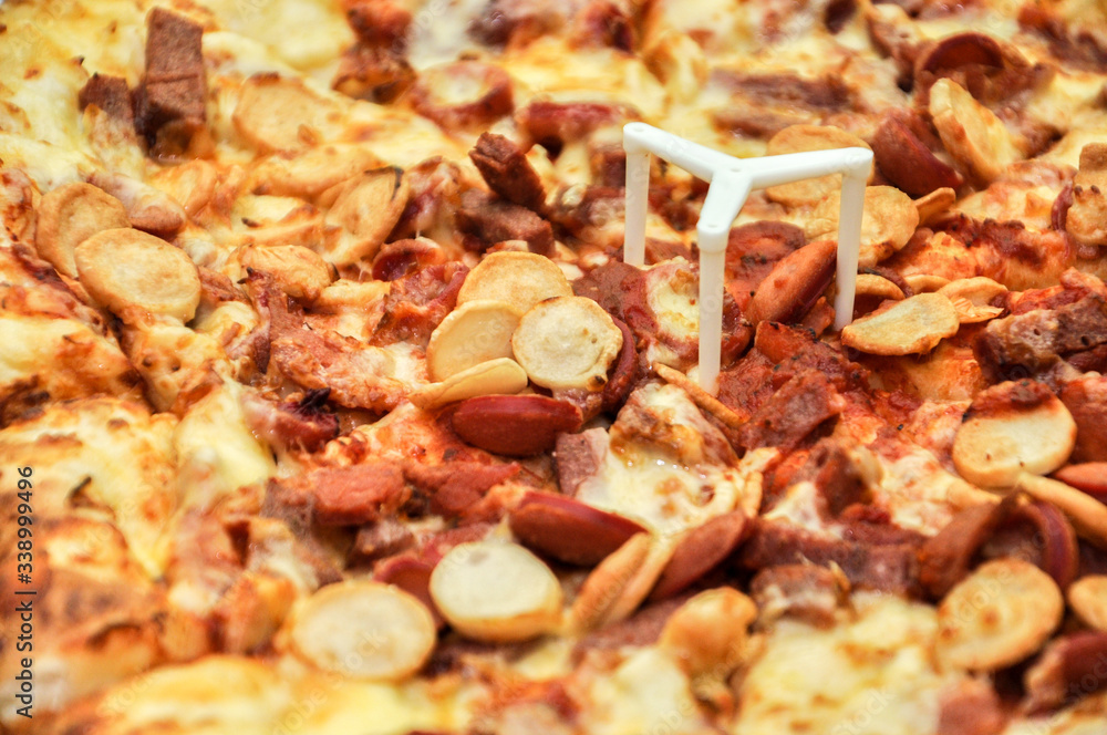 A Pan of pizza full with meat and cheese topping. A Pan of pizza full with meat and cheese topping.