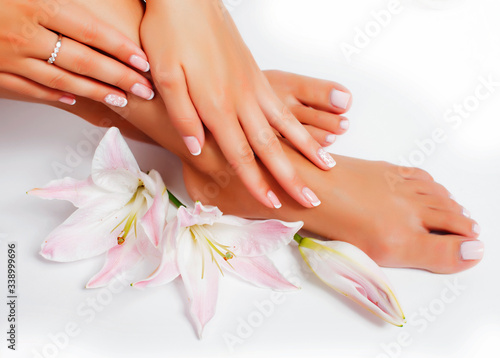 manicure pedicure with flower lily closeup isolated on white background perfect shape hands spa salon