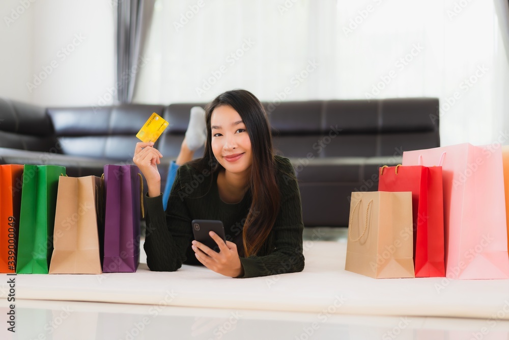 Portrait beautiful young asian woman with shopping bag and credit card Portrait beautiful young asian woman with shopping bag and credit card