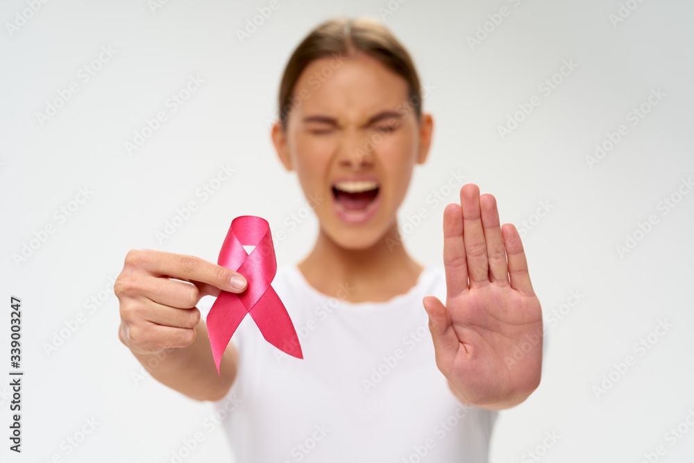Emotional woman with a ribbon in the hands of a charity foundation Emotional woman with a ribbon in the hands of a charity foundation