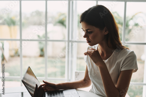 Woman at home in front of laptop chatting vacation Free Download Woman at home in front of laptop chatting vacation - GFXLoad