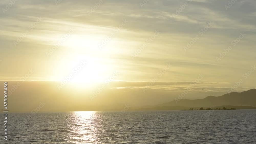 Golden sunrise over Pacific Ocean next to a tropical shoreline Golden sunrise over Pacific Ocean next to a tropical shoreline