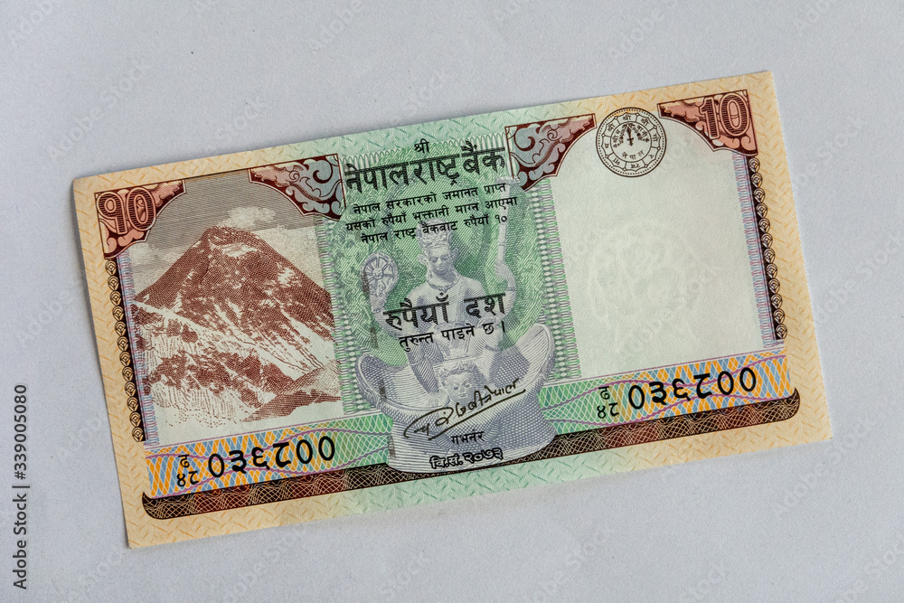 A Nepal paper currency banknote isolated on a white background. A Nepal paper currency banknote isolated on a white background.