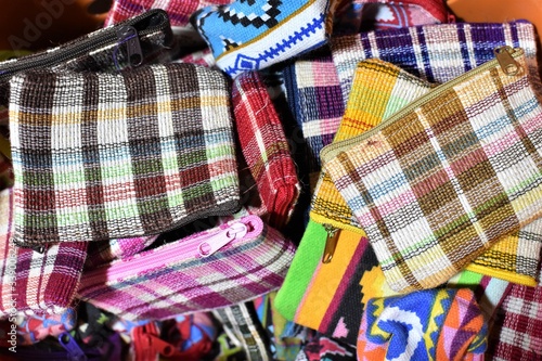 A pile of coin purses with checkered designs in different colors