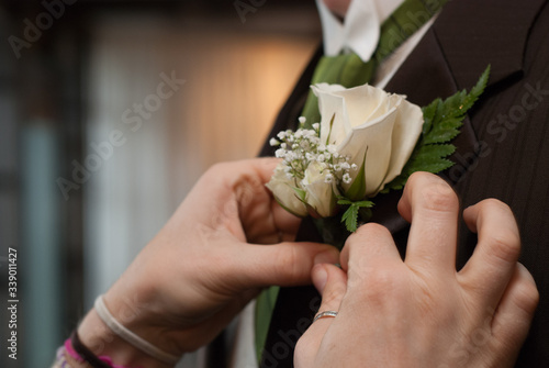 wedding flowers pinned to suit