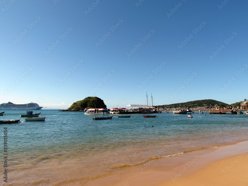 Boats anchored in the clear, placid waters of Búzios Bay