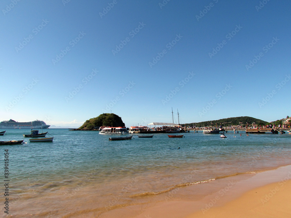 Fototapeta premium Boats anchored in the clear, placid waters of Búzios Bay
