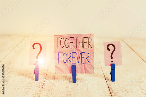 Handwriting text Together Forever. Conceptual photo showing who promise to love one another for eternity Scribbled and crumbling sheet with paper clips placed on the wooden table photo