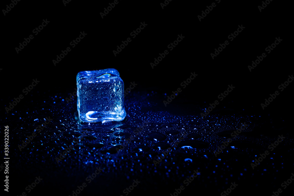 Blue ice cubes reflection on black table background. Blue ice cubes reflection on black table background.