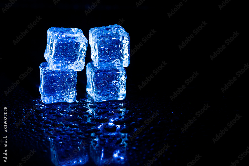 Blue ice cubes reflection on black table background. Blue ice cubes reflection on black table background.