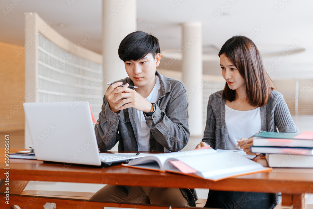 High school or college students group catching up workbook and learning tutoring on desk and reading, doing homework, lesson practice preparing exam. High school or college students group catching up workbook and learning tutoring on desk and reading, doing homework, lesson practice preparing exam.
