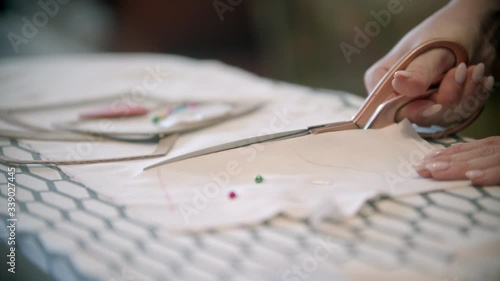 Cutting the white cloth following the soap marks photo