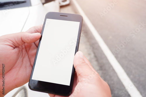 Cropped shot view of business human’s hands holding the mobile phone with blank copy space screen for your information content or text message, the woman reading text message on the smart phone during