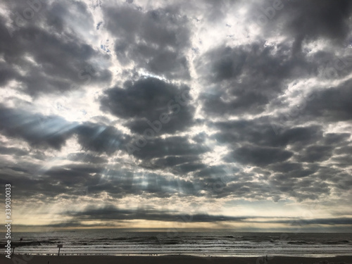 sun shining down through clouds above Gulf of Mexico © Zachariah Clark