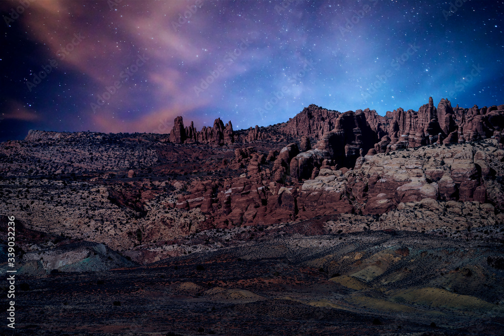Φωτογραφία The desert landscape under a mystical violet night sky in Arches National Park near Moab, Utah, USA