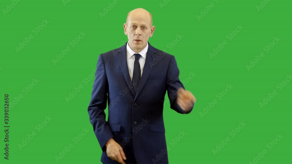 Serious businessman pointing left and right on green screen. The man is wearing a suit and gestures with his finger as he points. Serious businessman pointing left and right on green screen. The man is wearing a suit and gestures with his finger as he points.