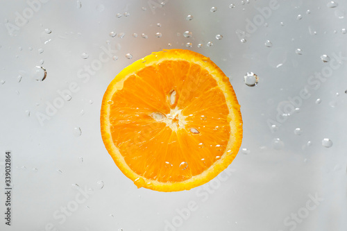 orange and drops of water on a window