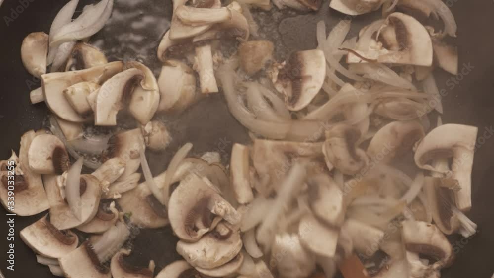 mushrooms with onions fried in a pan, view from the top mushrooms with onions fried in a pan, view from the top