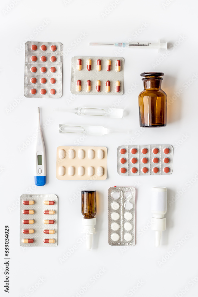 Cold, flu and virus treatment - flat lay with medicine - on white background top view Cold, flu and virus treatment - flat lay with medicine - on white background top view