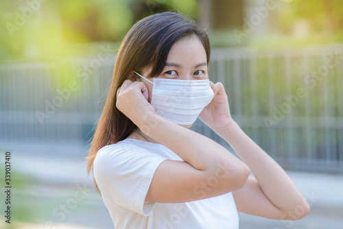 Coronavirus and Air pollution pm2.5 concept.Asian woman wearing medical face mask. Woman Wearing Protective Mask. Woman wearing surgical mask for corona virus.