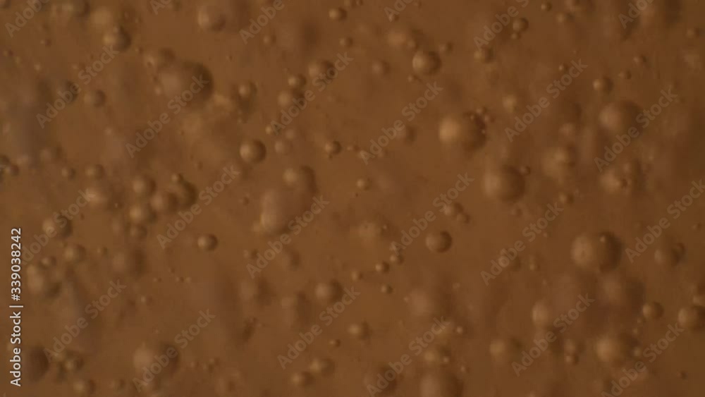 Macro shot of chaotic movement of bubbles floating around in orange liquid. Macro shot of chaotic movement of bubbles floating around in orange liquid.