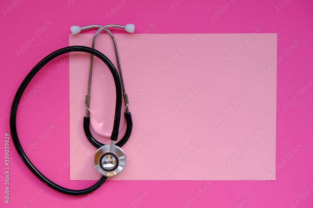 Fototapeta premium Medicine and health concept.Medical layout in pink colors. Women's diseases theme. A stethoscope on a pink background. Medical frame with copy space.cold and flu.