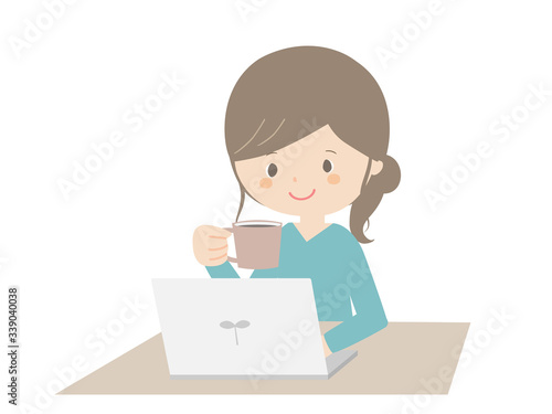 Woman drinking coffee while looking at the computer.