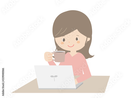 Woman drinking coffee while looking at the computer.