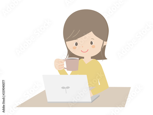 Woman drinking coffee while looking at the computer.