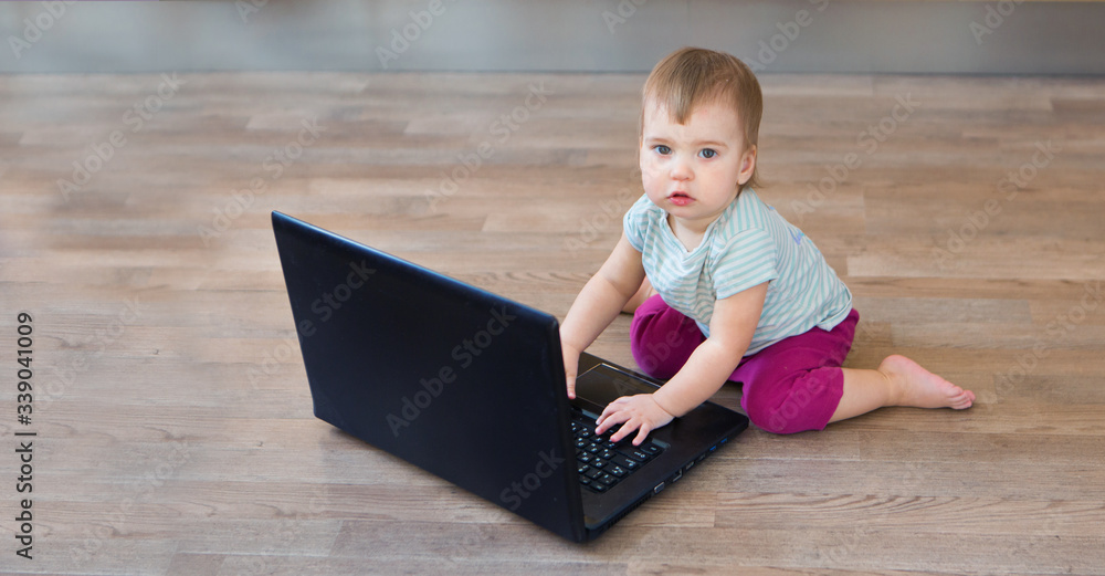 small child plays on computer. The child Prodigy learns the techniques of business Planning, home work, quarantine, self-isolation, protection from coronavirus, virus, home education, distance work. small child plays on computer. The child Prodigy learns the techniques of business Planning, home work, quarantine, self-isolation, protection from coronavirus, virus, home education, distance work.