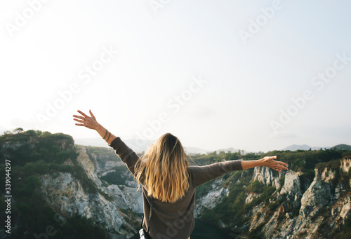 Carefree woman arms outstretched on the mountain