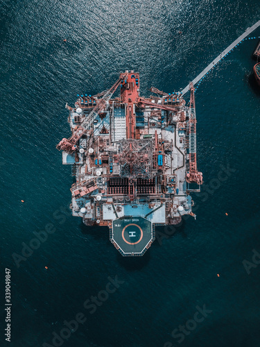 Aerial view of oil rig platform in the middle of ocean.