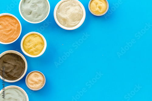 Yellow, red, white, blue and black cosmetic clay top view copy space