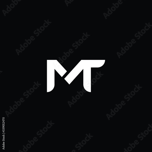 Minimal elegant monogram art logo. Outstanding professional trendy awesome artistic MT TM initial based Alphabet icon logo. Premium Business logo White color on black background photo