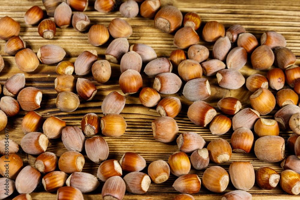 Heap of hazelnuts on a wooden table Heap of hazelnuts on a wooden table