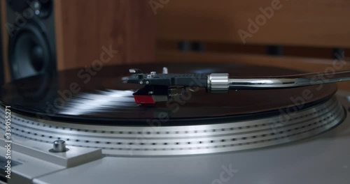 A Vinyl Player Stopped Playing Music Lifting the Tonearm and Stopping the Motor photo