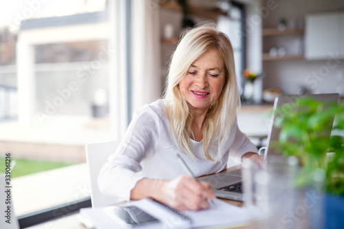 Free Download Senior woman with laptop indoors in home office, working. - GFXLoad