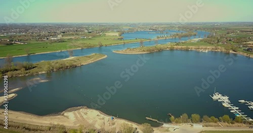 Aerial drone shot of flying forward to the lake near the canal with some small boats docking in the Netherlands. photo