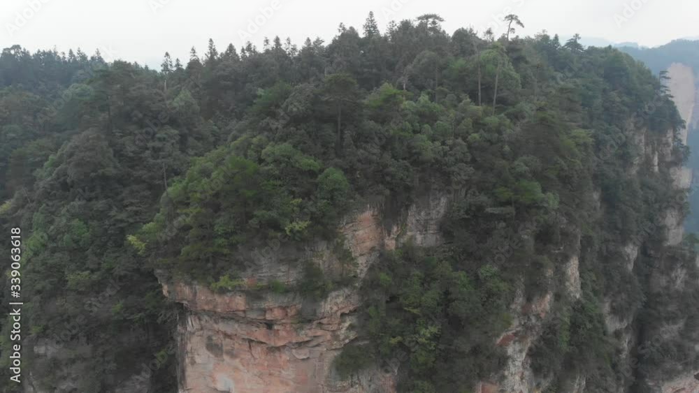 Aerial zoom out from an incredible karst mountain in Zhangjiajie National Forest Park, China Aerial zoom out from an incredible karst mountain in Zhangjiajie National Forest Park, China
