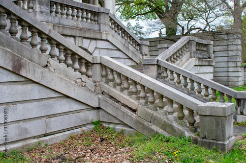 A Detailed Set of Stone Steps Leading Up to an Estate From a Grass Courtyard With a Crack in the Side