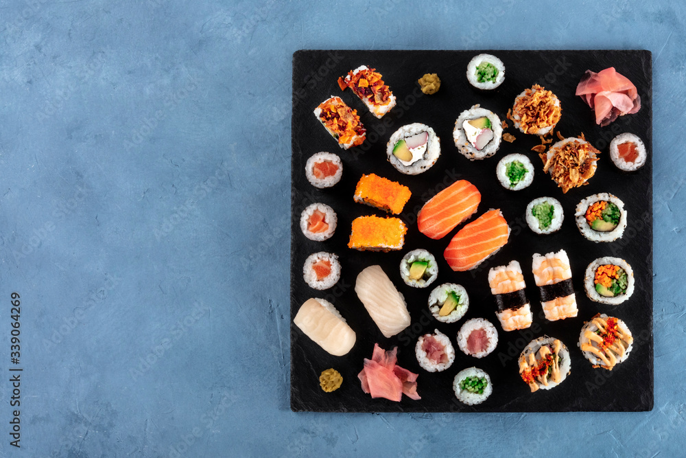 Obraz premium Large sushi set, shot from the top with copy space. Many different maki, nigiri and rolls